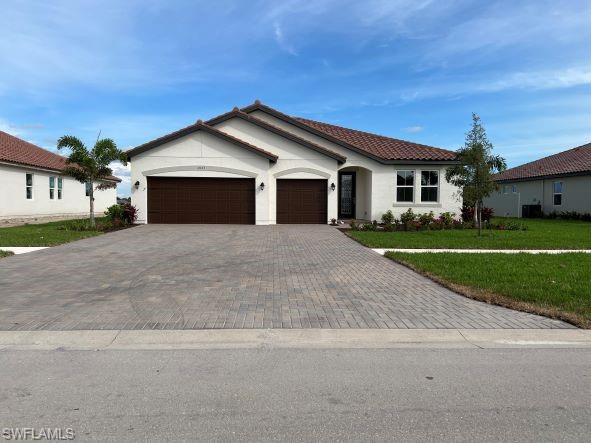 a front view of a house with a yard and garage