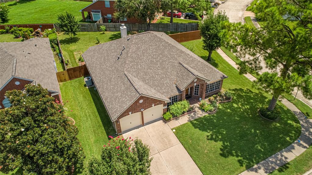 an aerial view of a house with garden space and street view