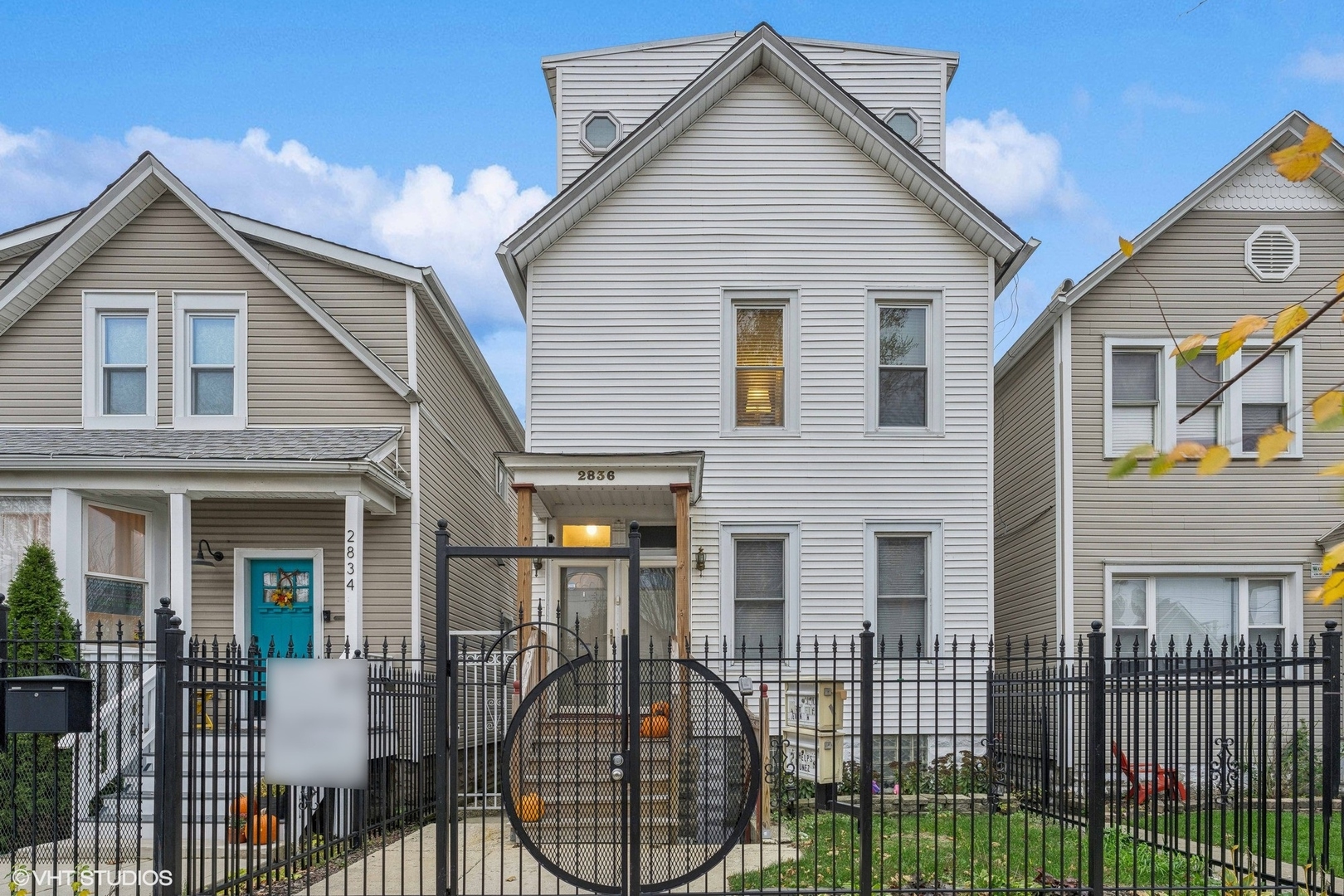 a front view of a house with a wooden fence