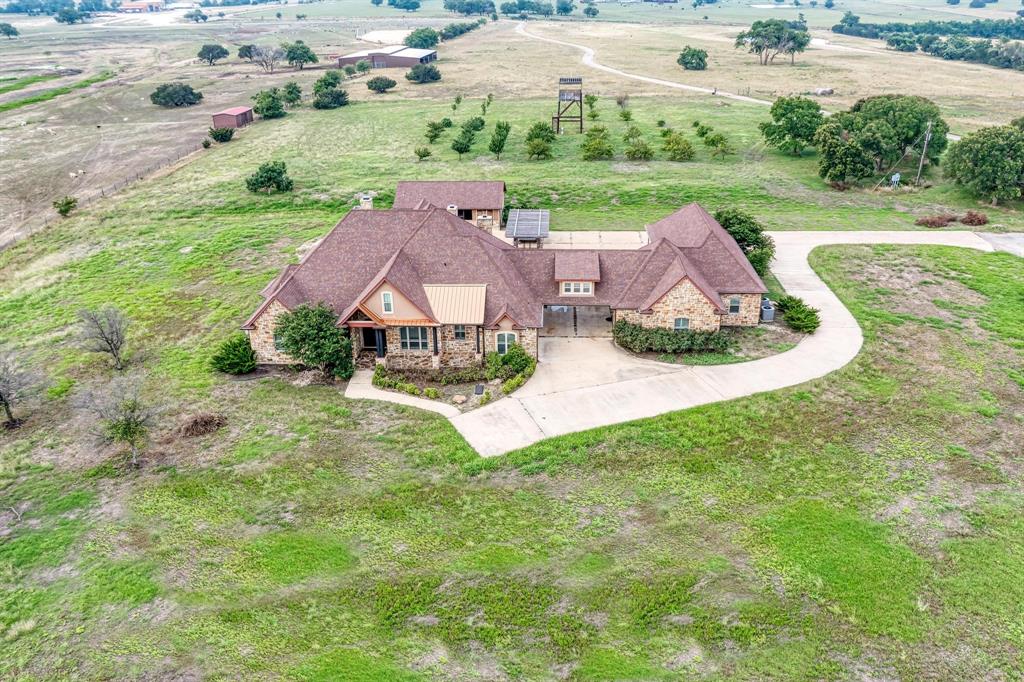 an aerial view of a house with garden space and street view