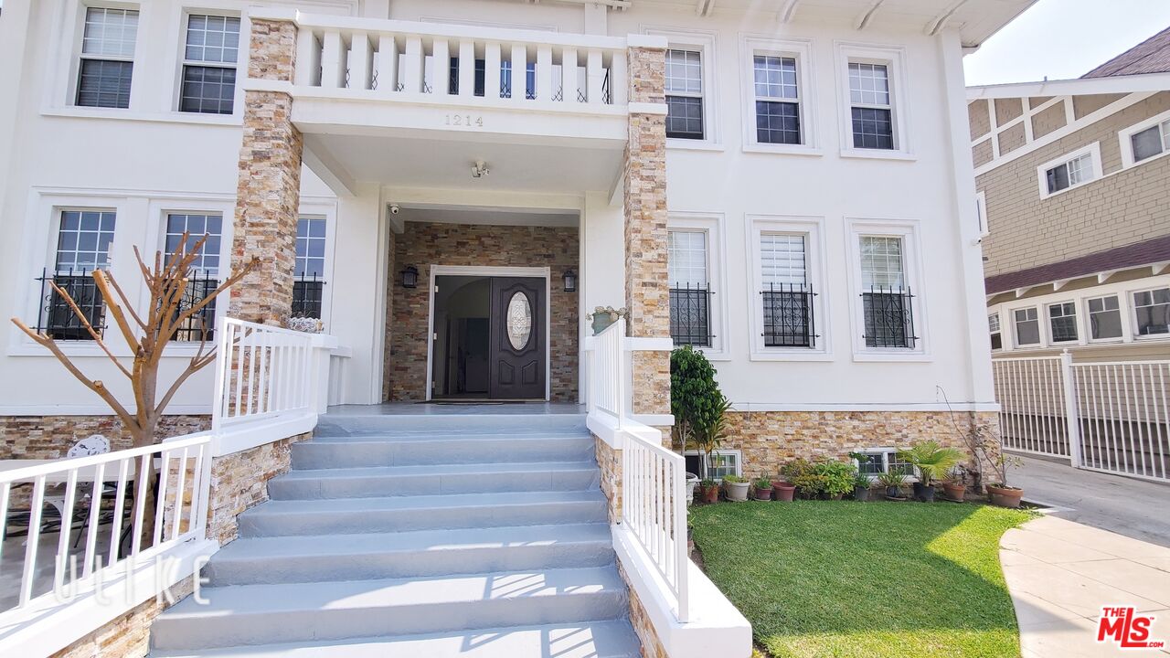 a front view of a house with a garden