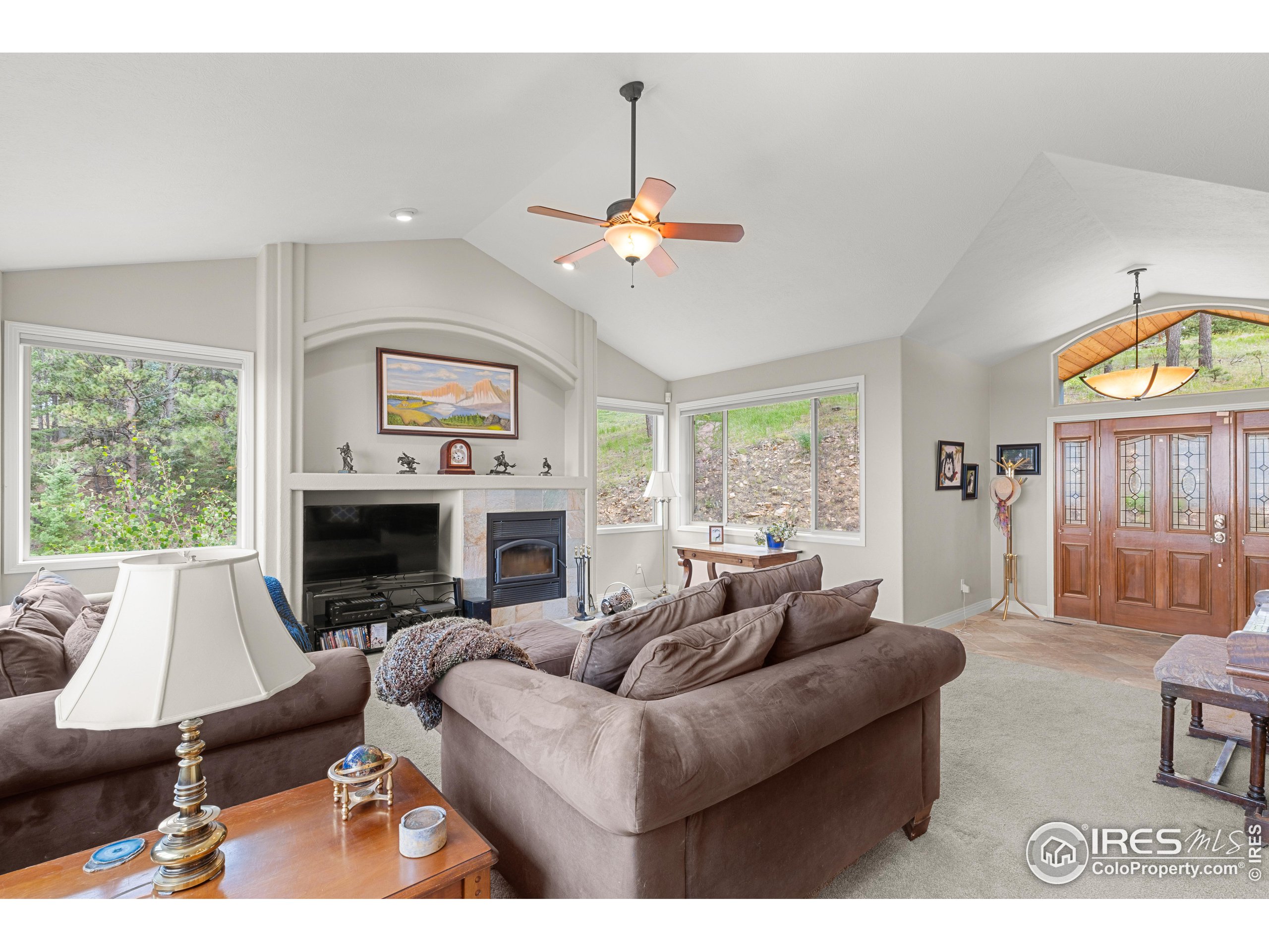 a living room with furniture a fireplace and a flat screen tv