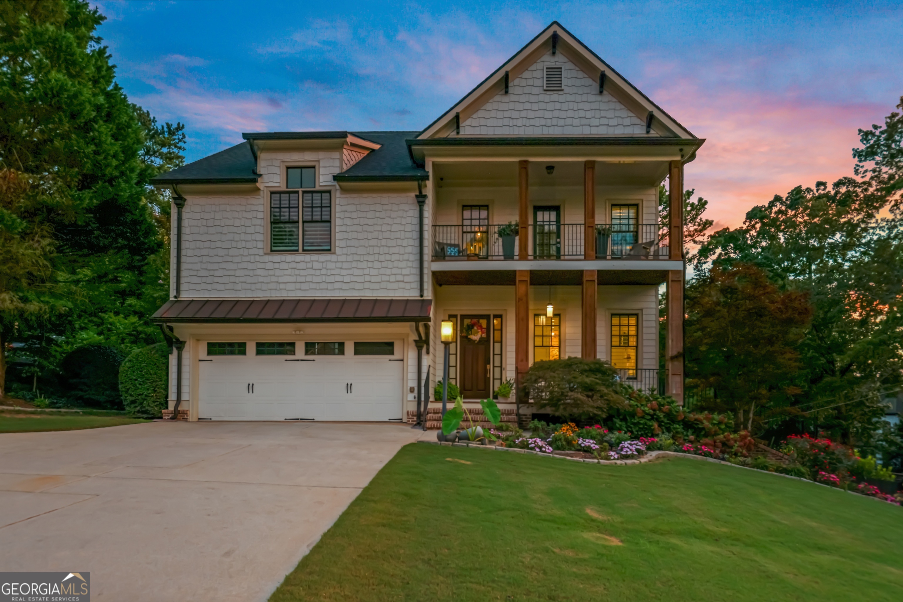 a front view of a house with a yard and garage