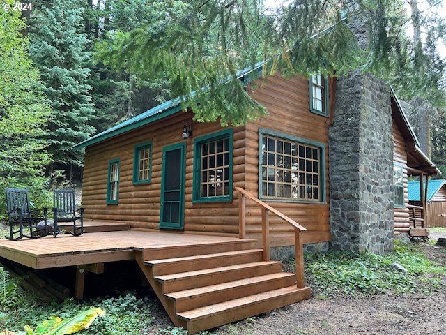 a front view of a house with stairs and a garden