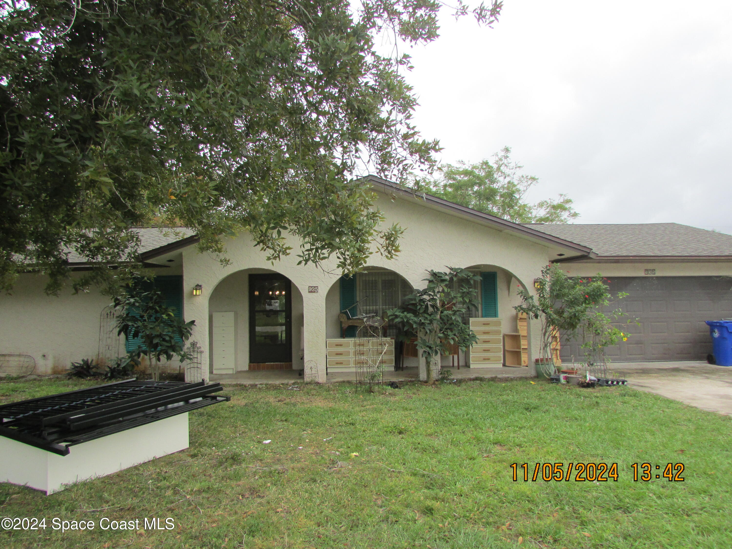 a front view of a house with garden