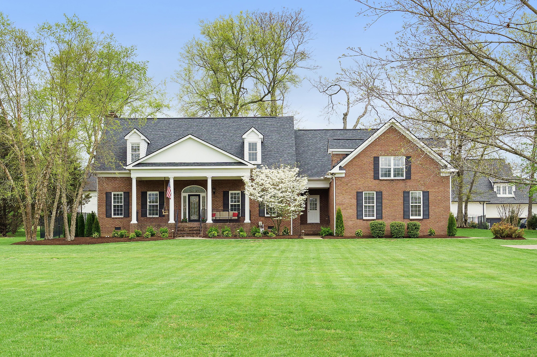 a front view of house with yard and green space