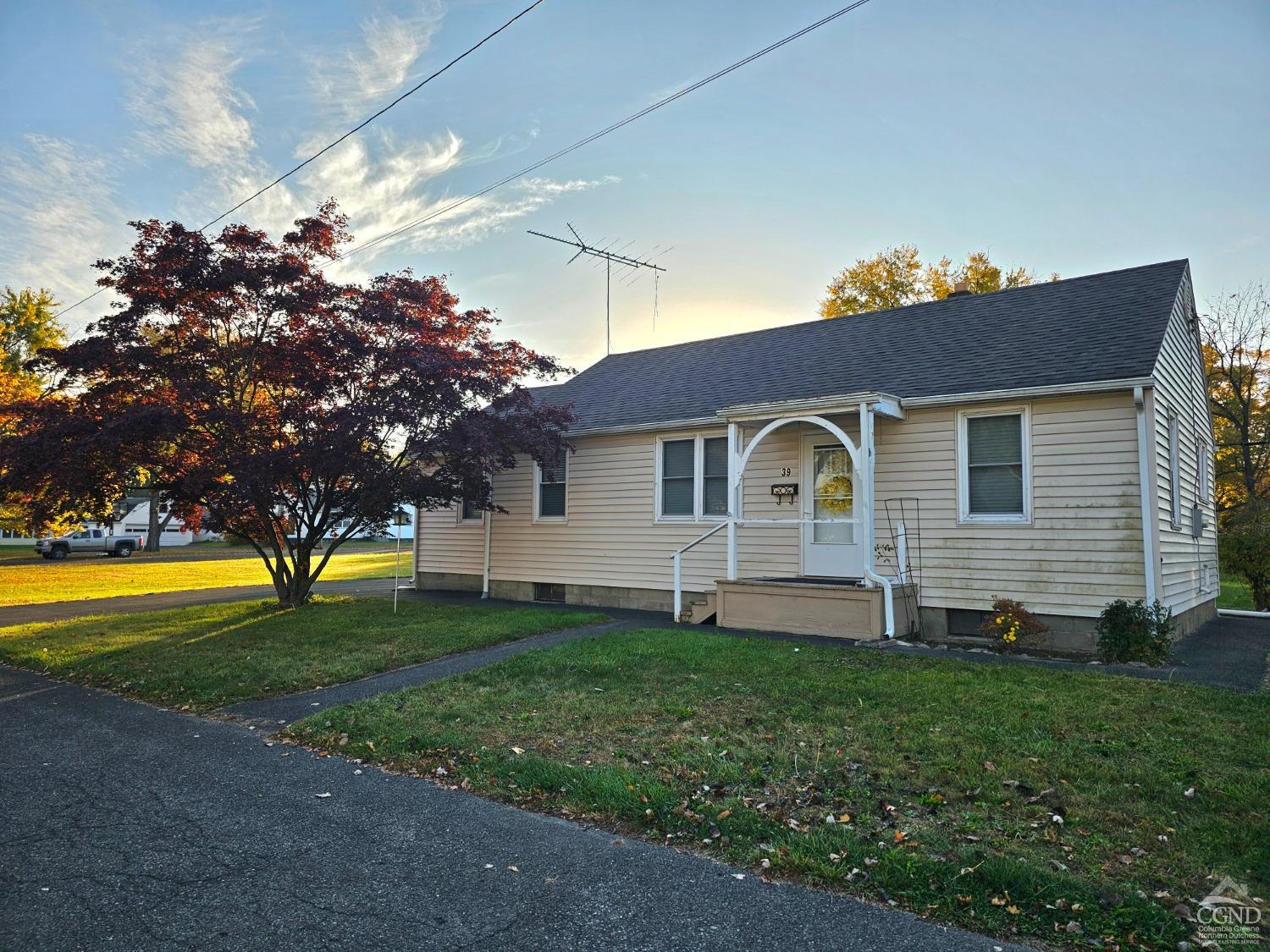 a front view of a house with a garden