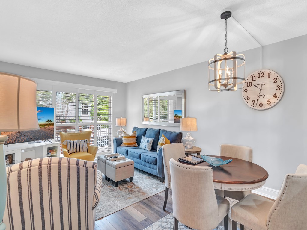 a living room with furniture a window and a chandelier