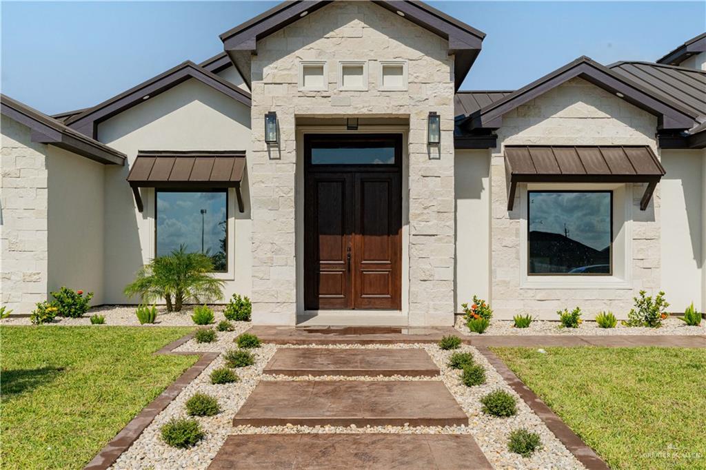 Entrance to property featuring a lawn