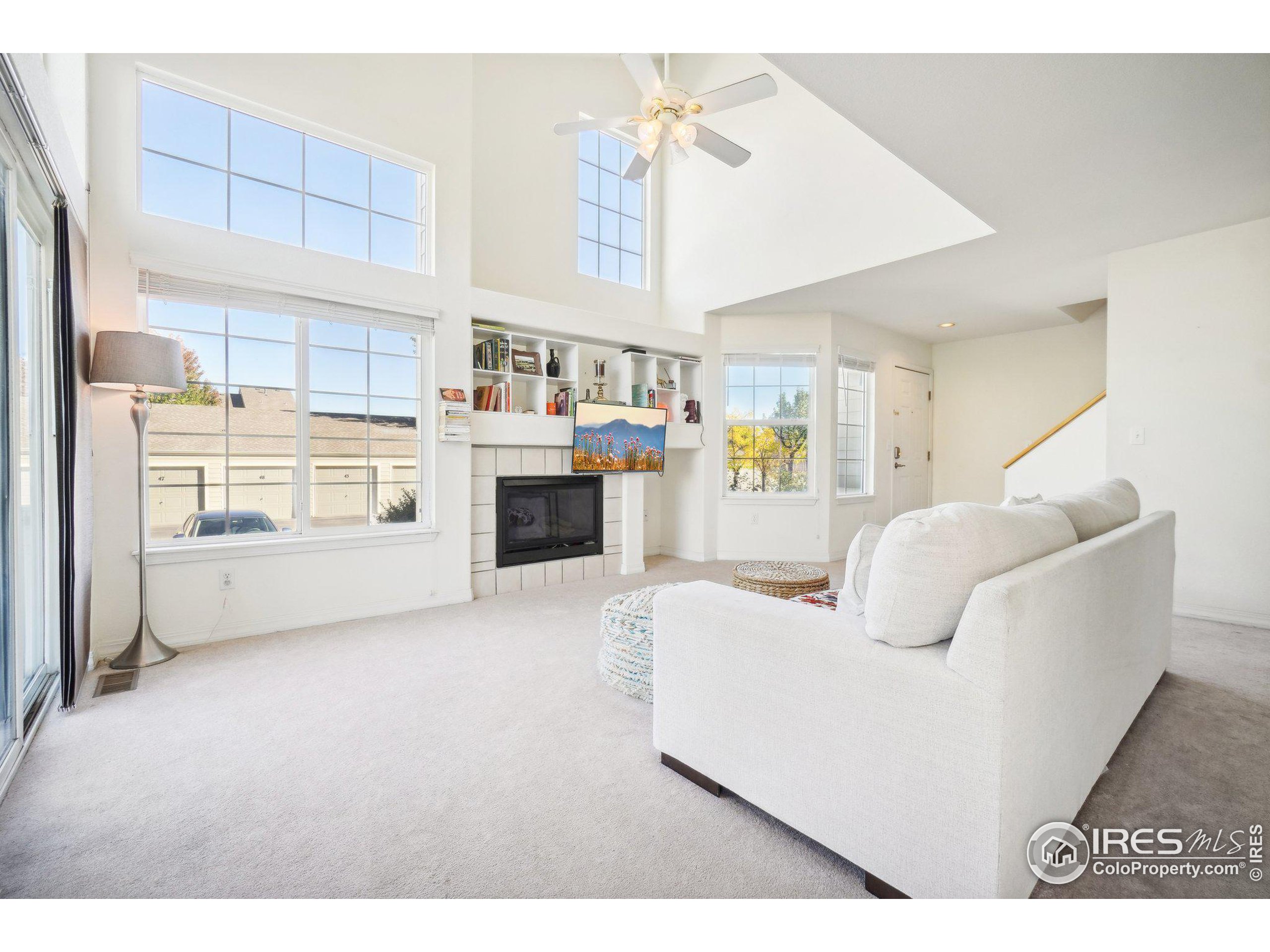 a living room with furniture and a kitchen view