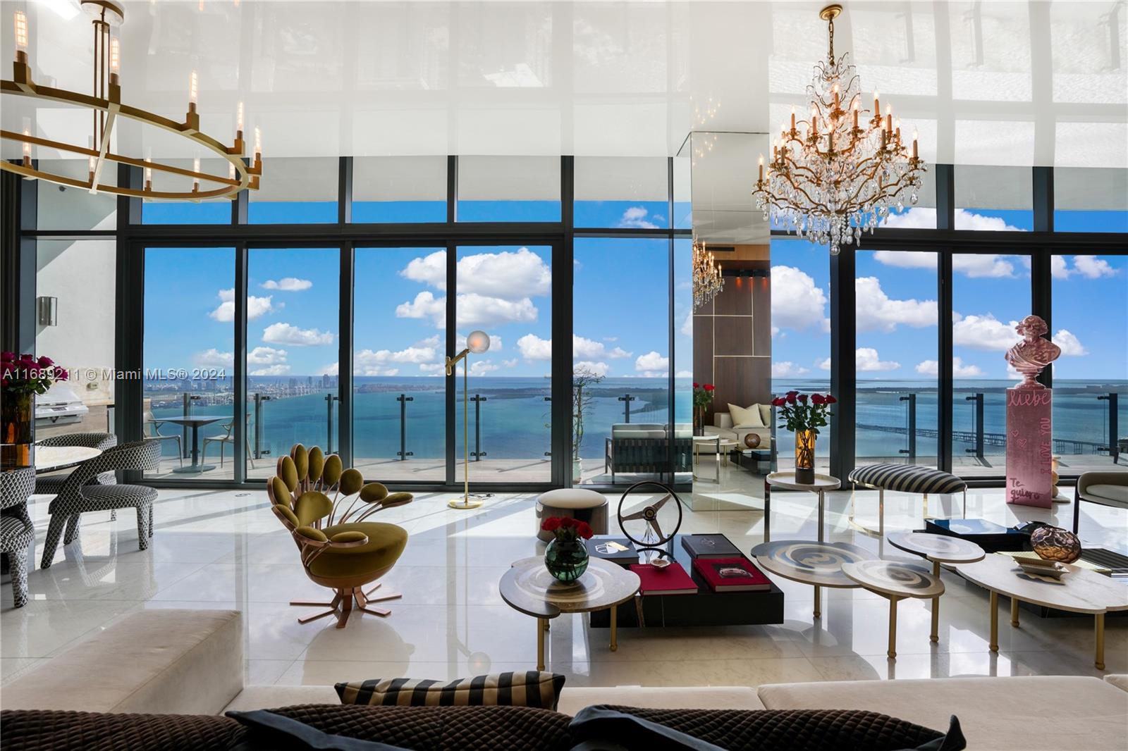 a living room with furniture and floor to ceiling windows