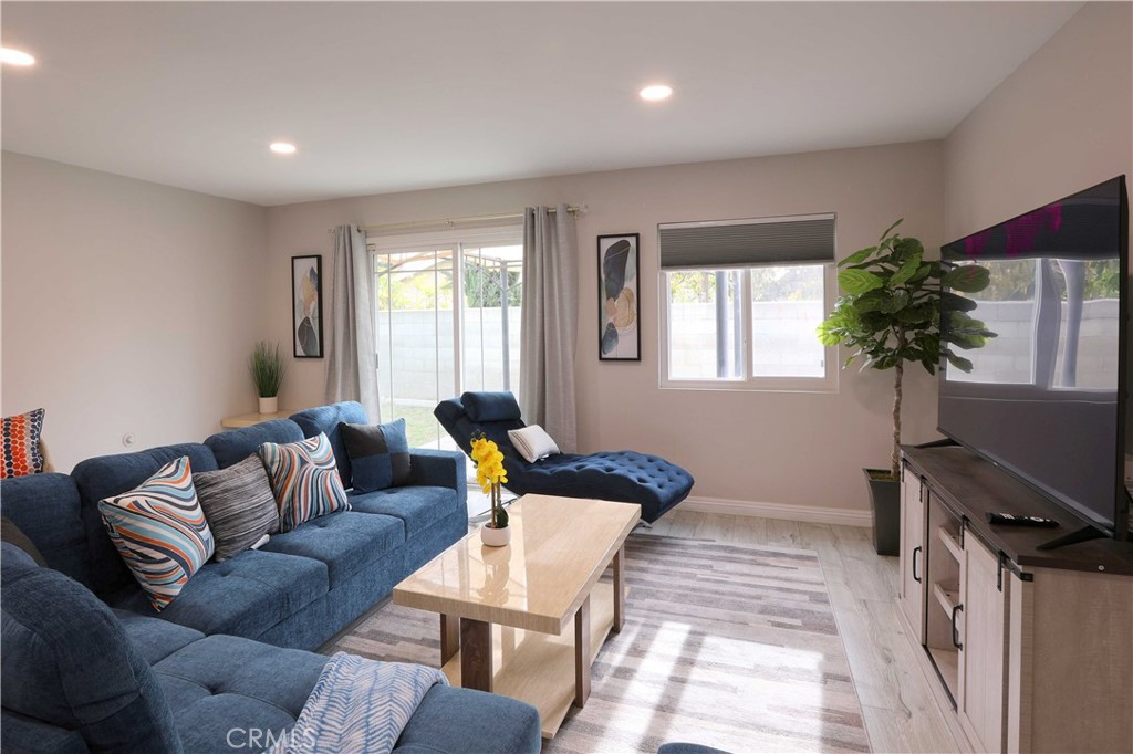 a living room with furniture and a potted plant