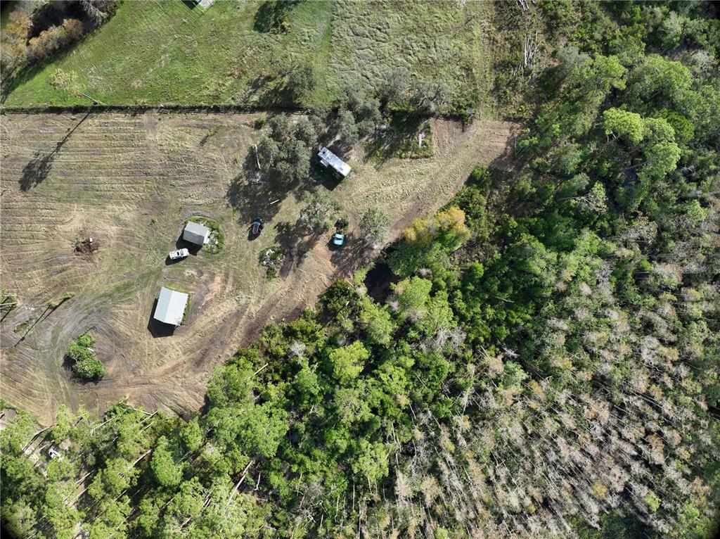 an aerial view of a house with a yard and swimming pool