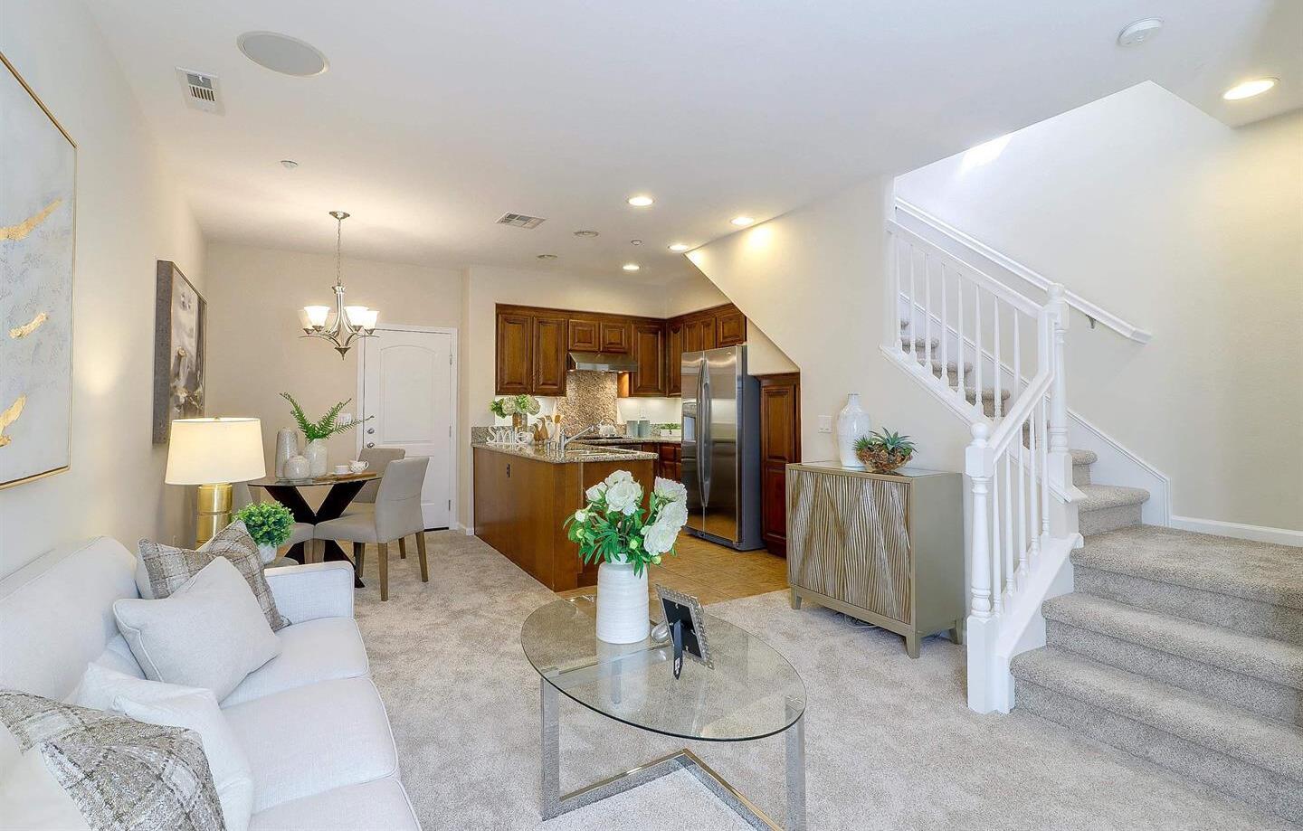 a living room with furniture and a chandelier