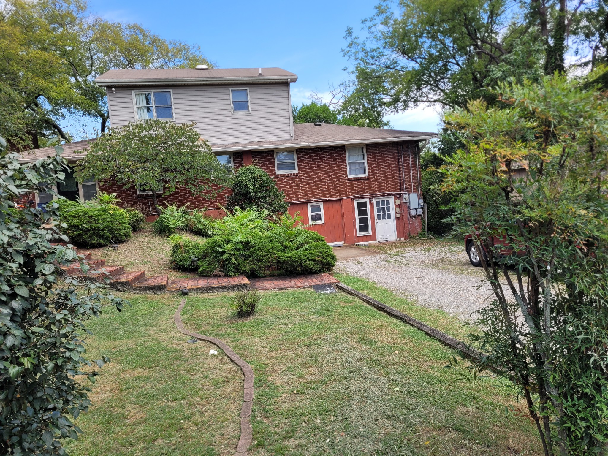 a view of a house with a yard and plants