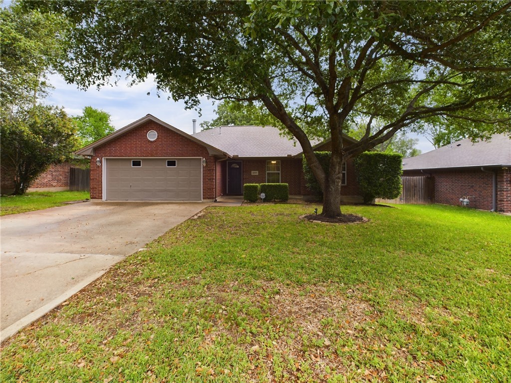 Ranch-style home featuring a garage and a front la