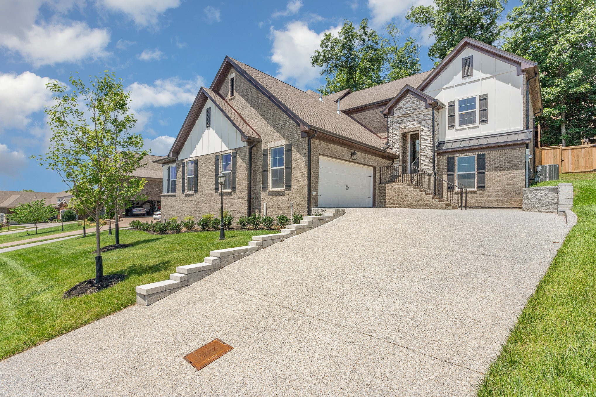 a front view of a house with a yard and trees