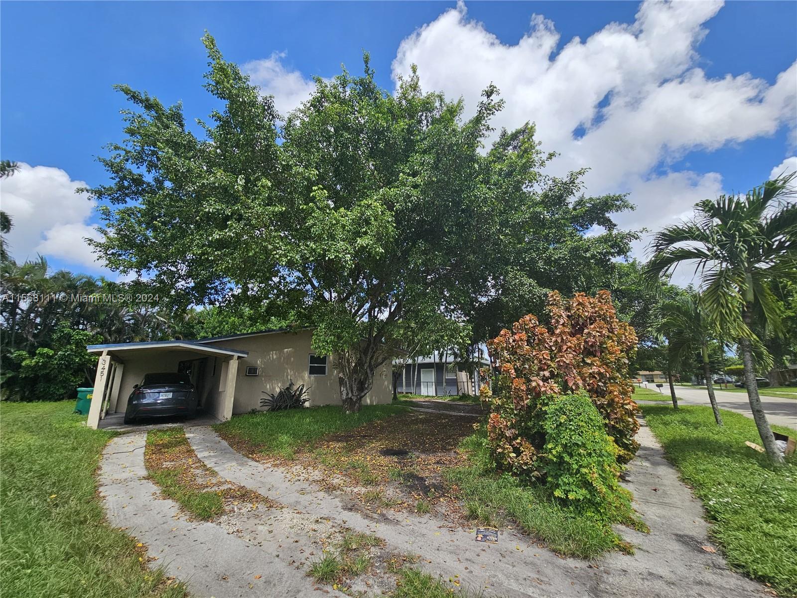 a view of a house with a yard and a garden