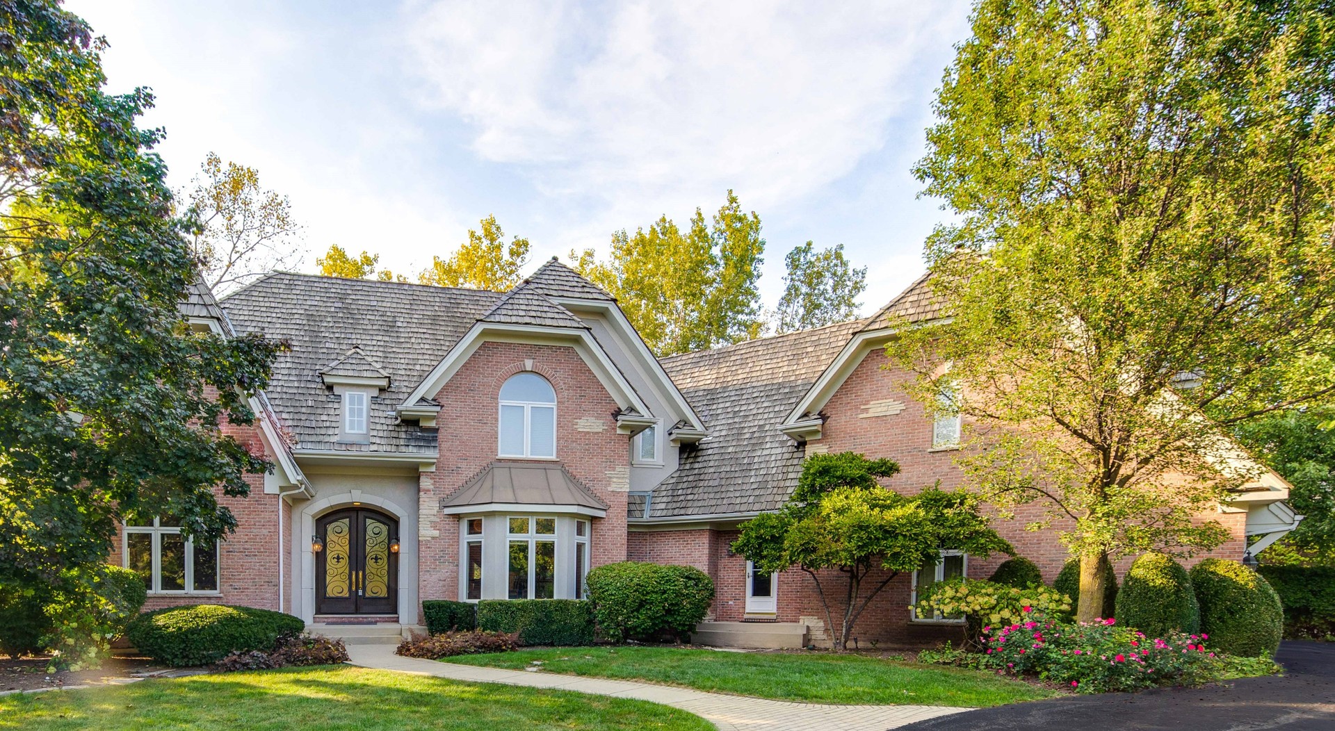 a front view of a house with garden