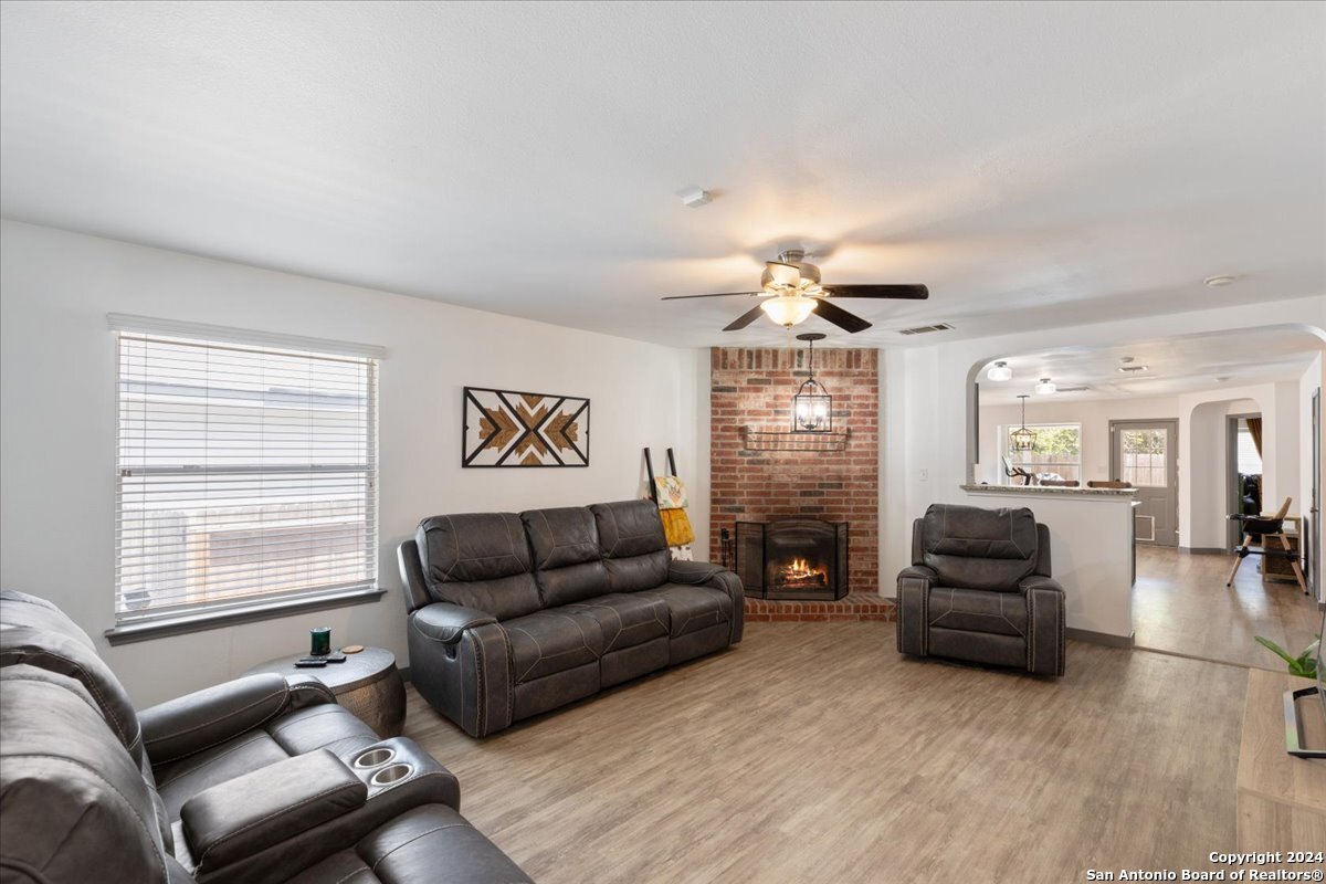 a living room with furniture window and wooden floor