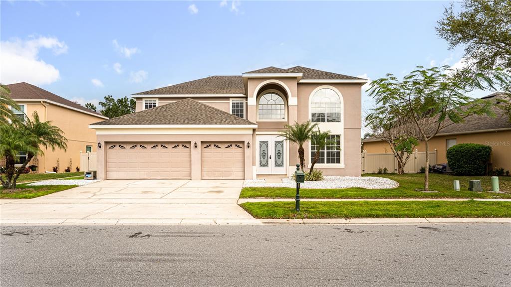 a front view of a house with a yard and garage