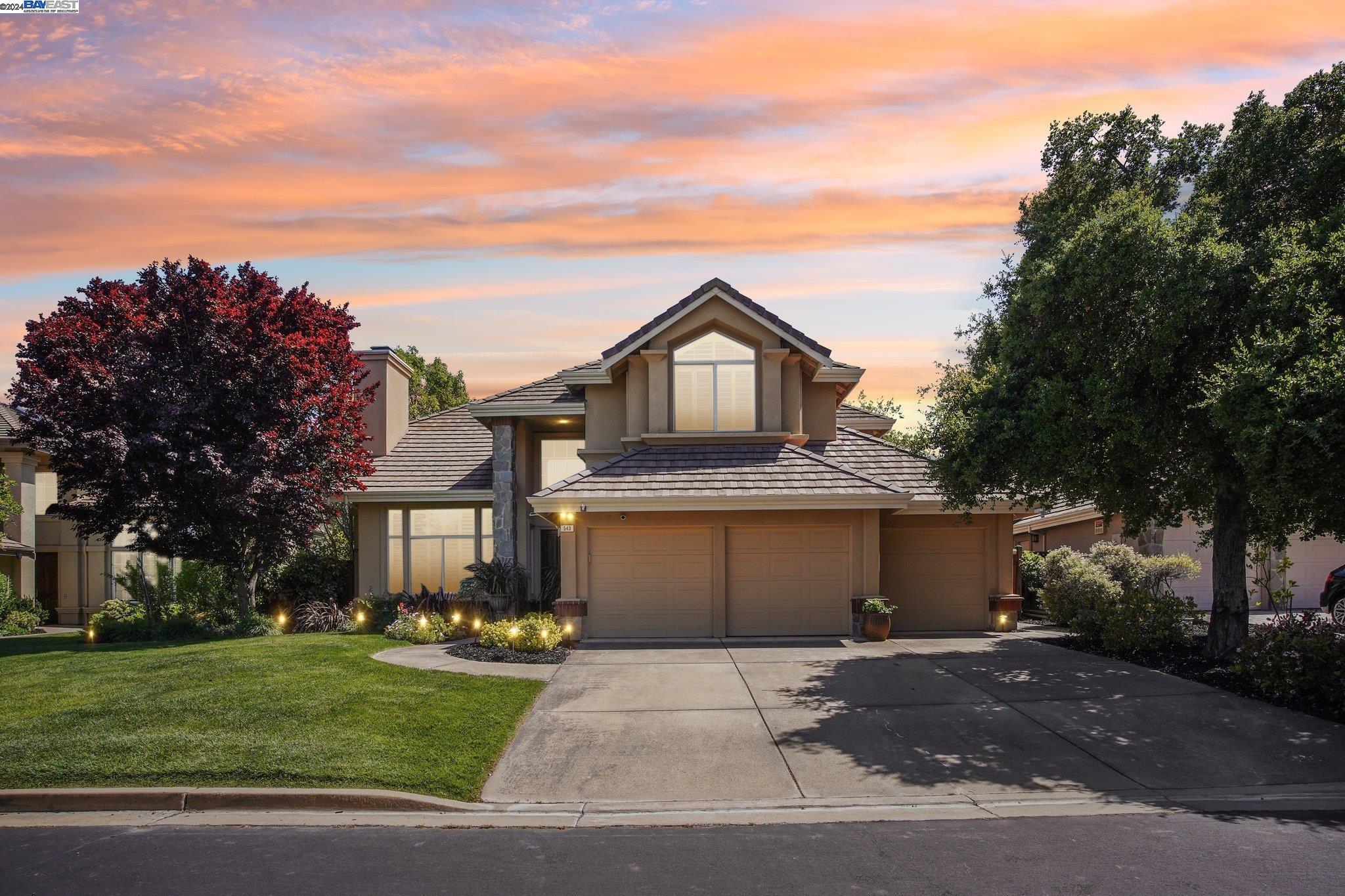 a front view of a house with a garden