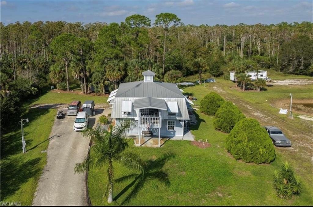 an aerial view of a house with yard swimming pool and outdoor seating