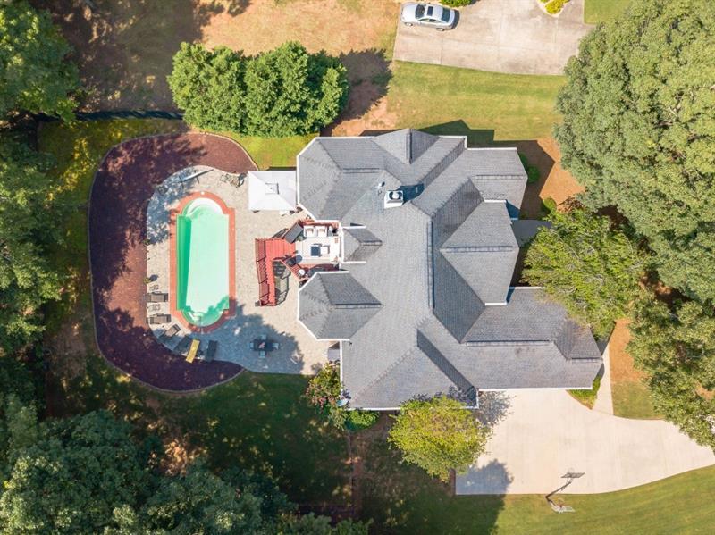 an aerial view of a house with yard swimming pool and outdoor seating