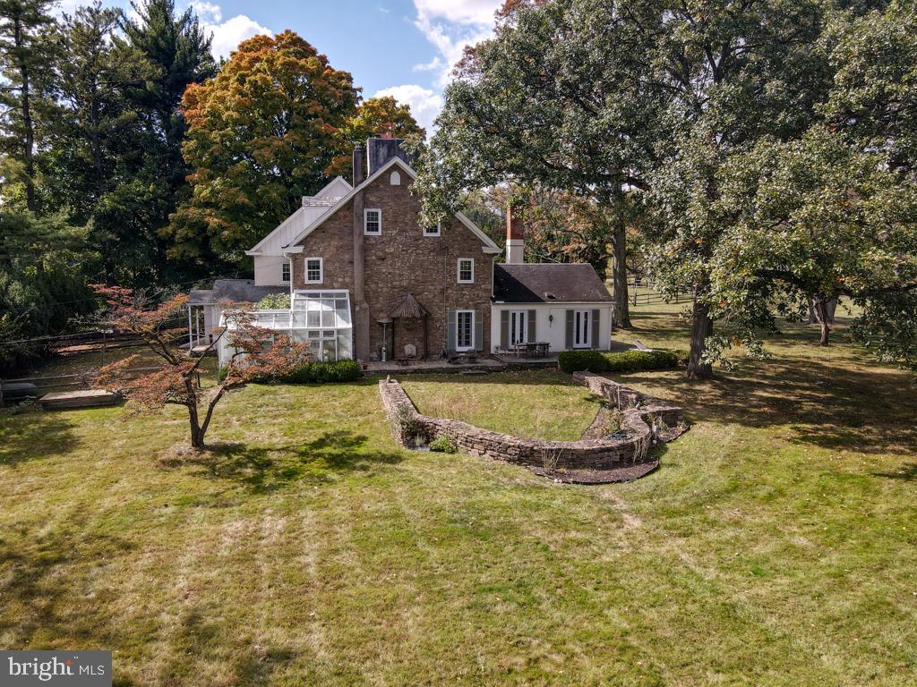 a view of a house with swimming pool and a yard