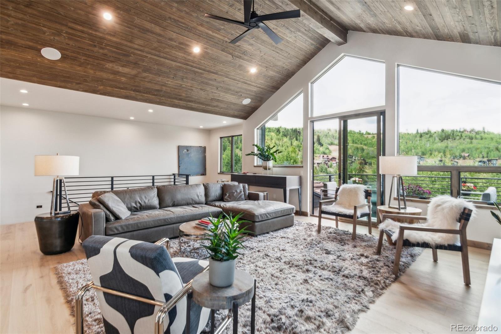 a living room with furniture and a floor to ceiling window