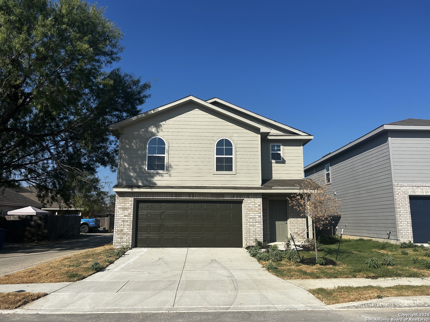 a front view of a house with garage