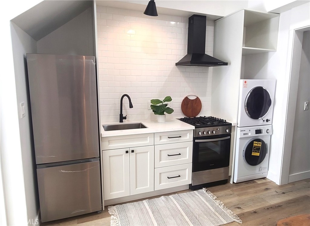 a kitchen with a stove and a refrigerator