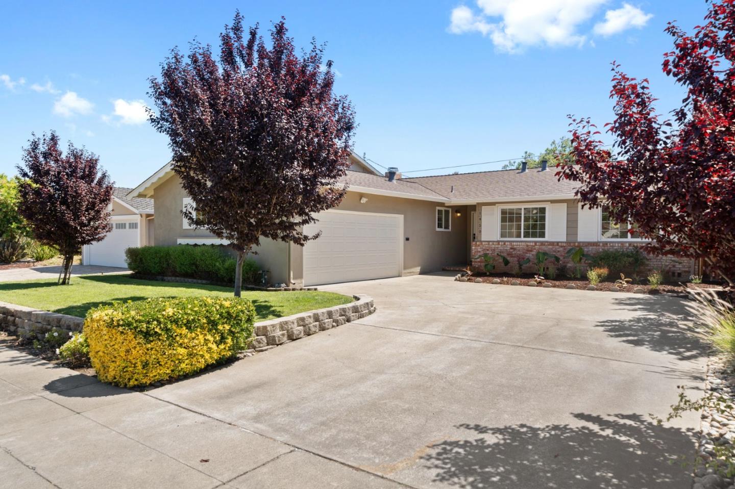 a front view of a house with a yard and a garage