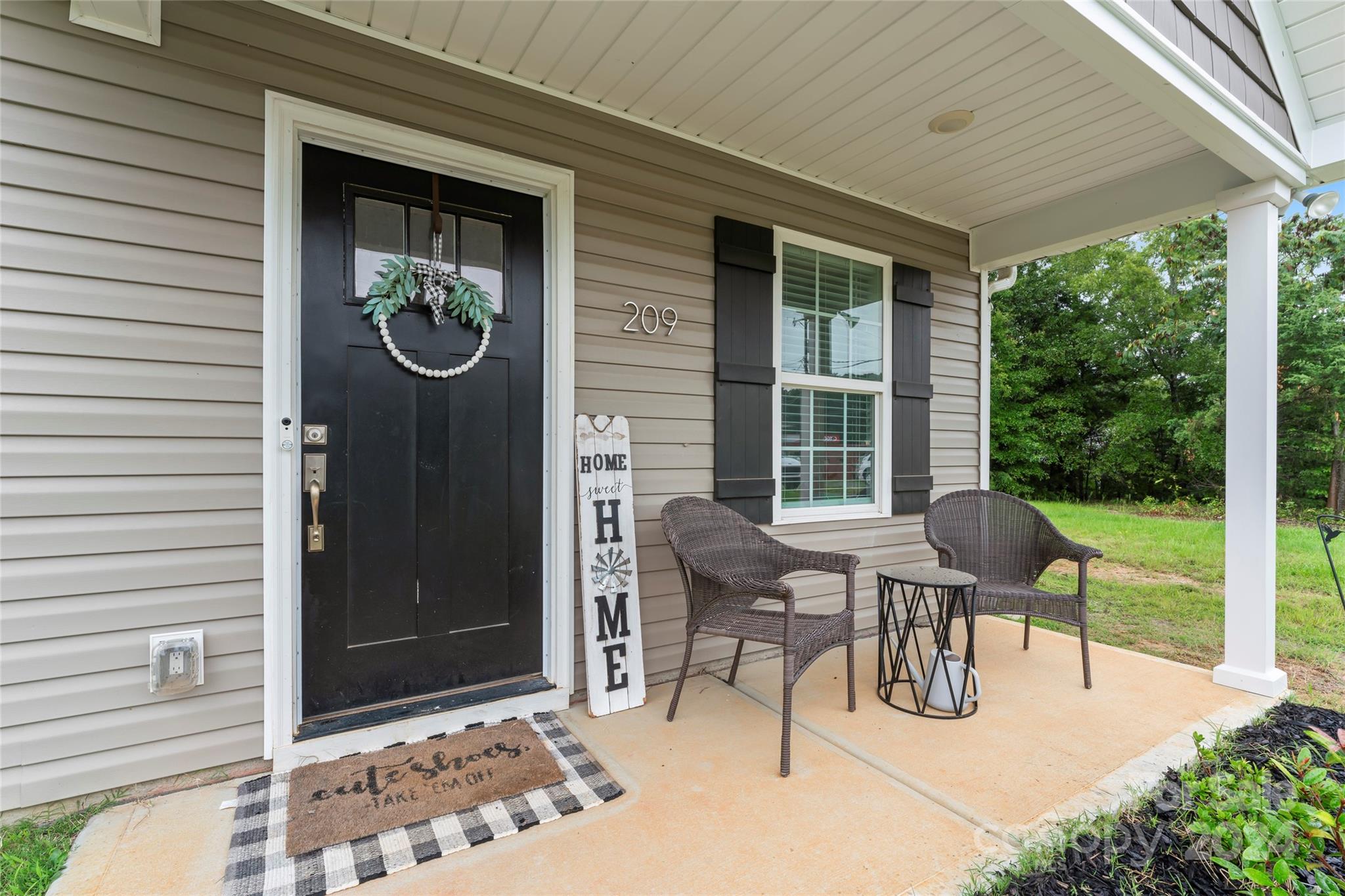 a view of a patio with table and chairs and wooden fence