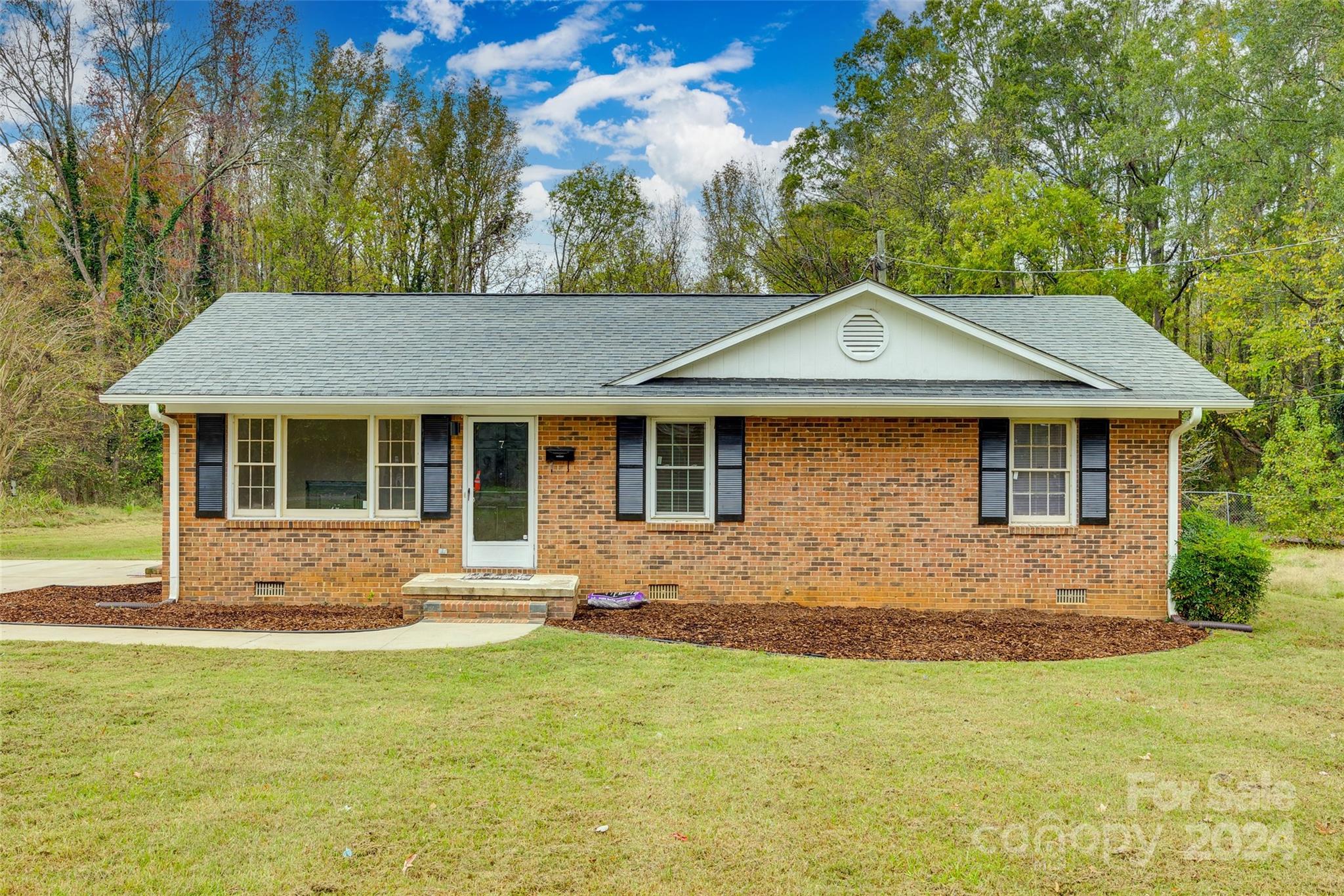 a front view of a house with yard