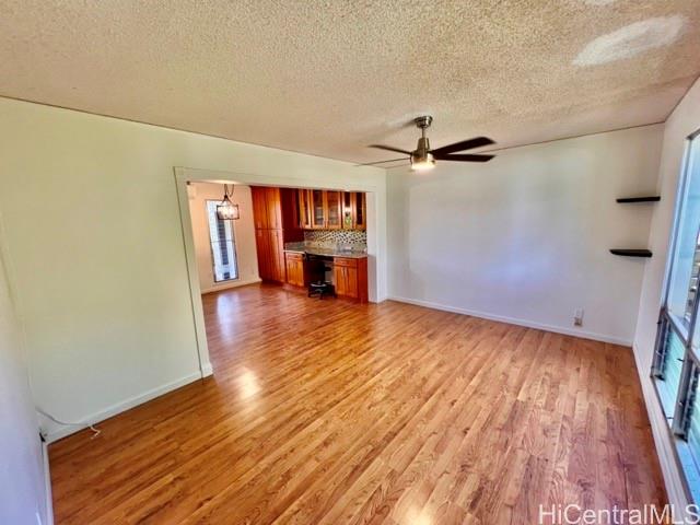 a view of a livingroom with a hardwood floor and a ceiling fan