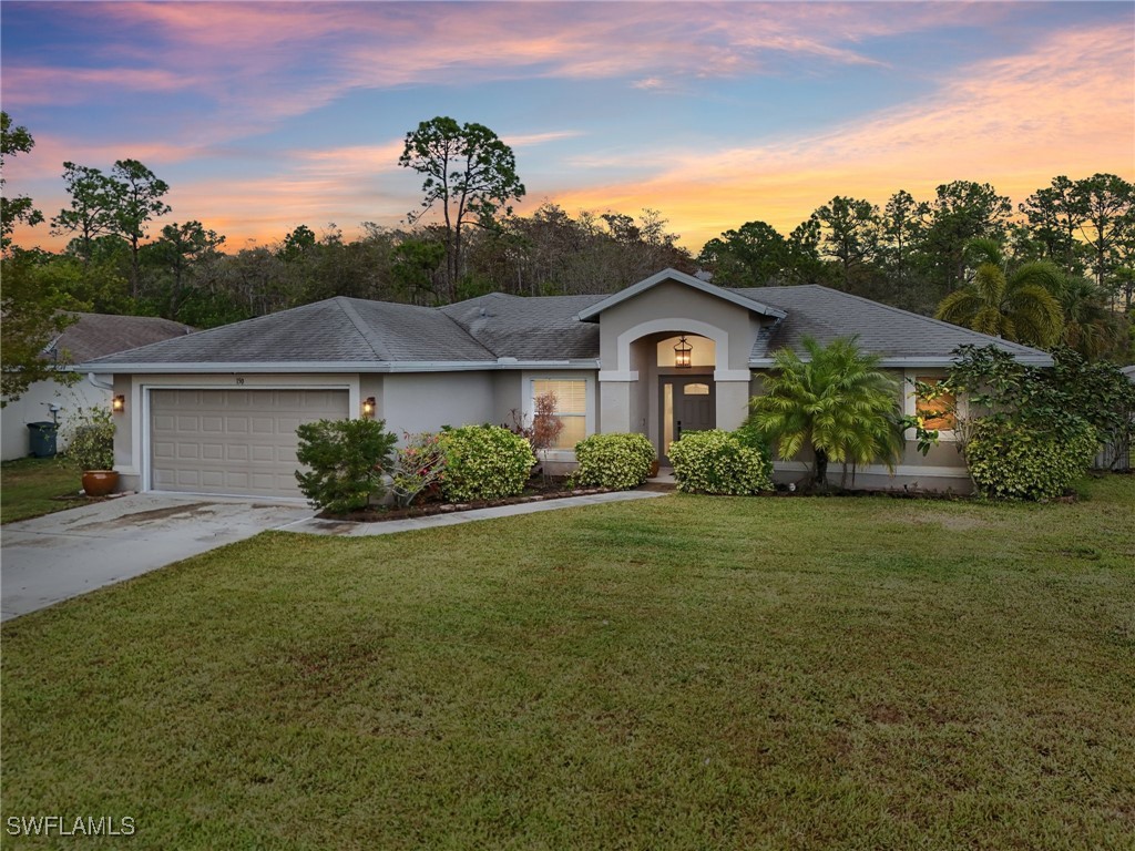 a front view of a house with a yard and garage