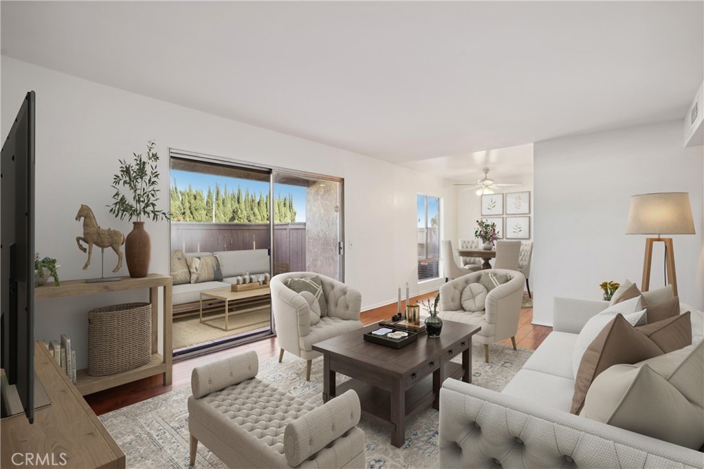 a living room with furniture and a painting on the wall