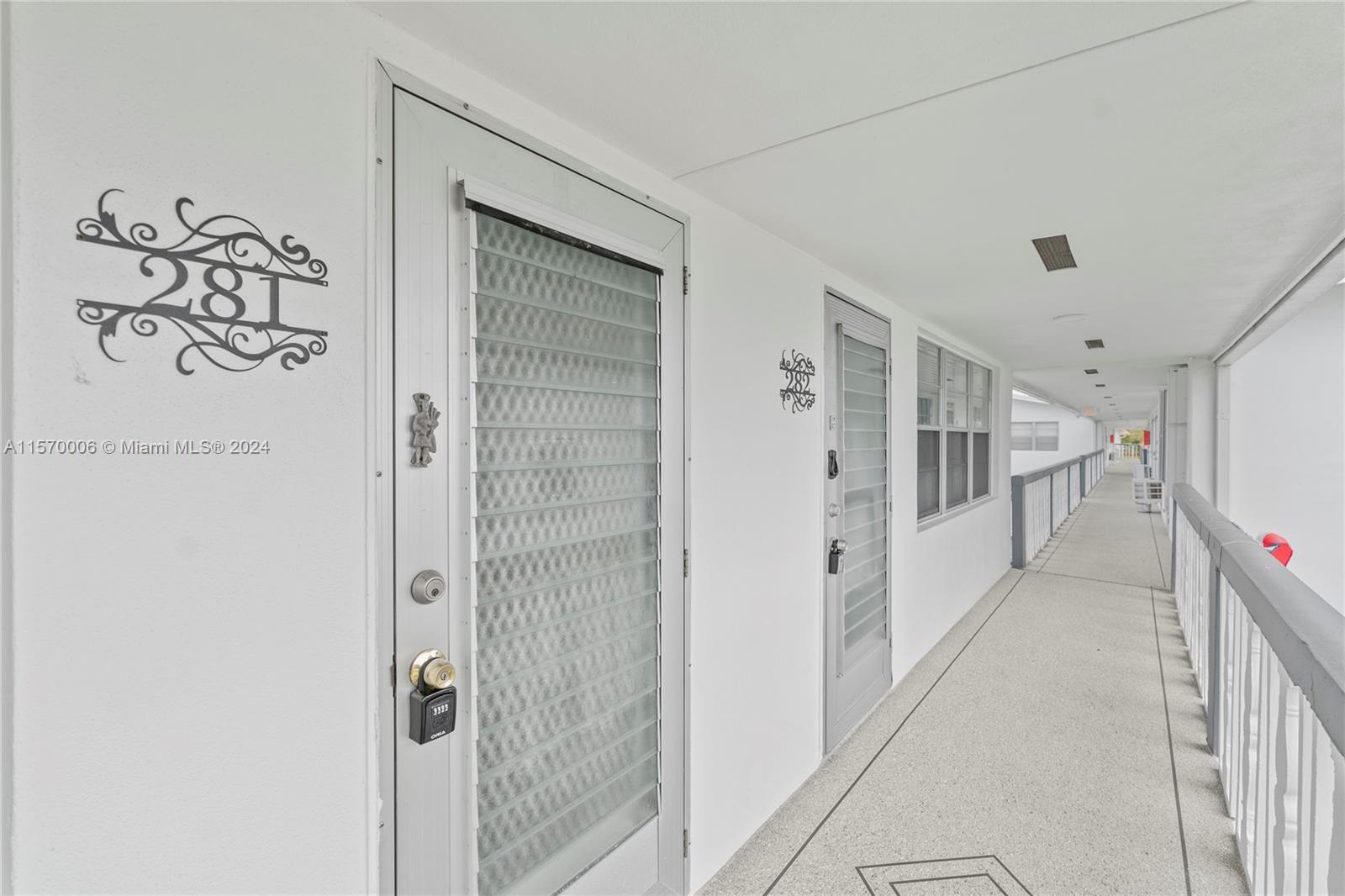 a view of a hallway with windows and entryway