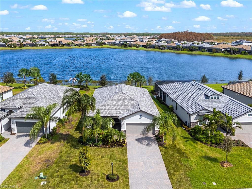 an aerial view of residential houses with outdoor space and ocean view