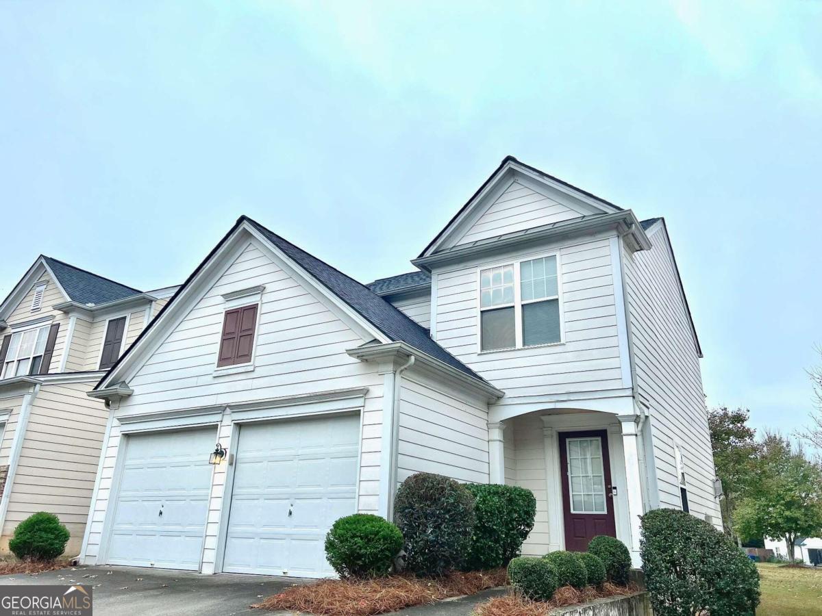 a front view of a house with garage