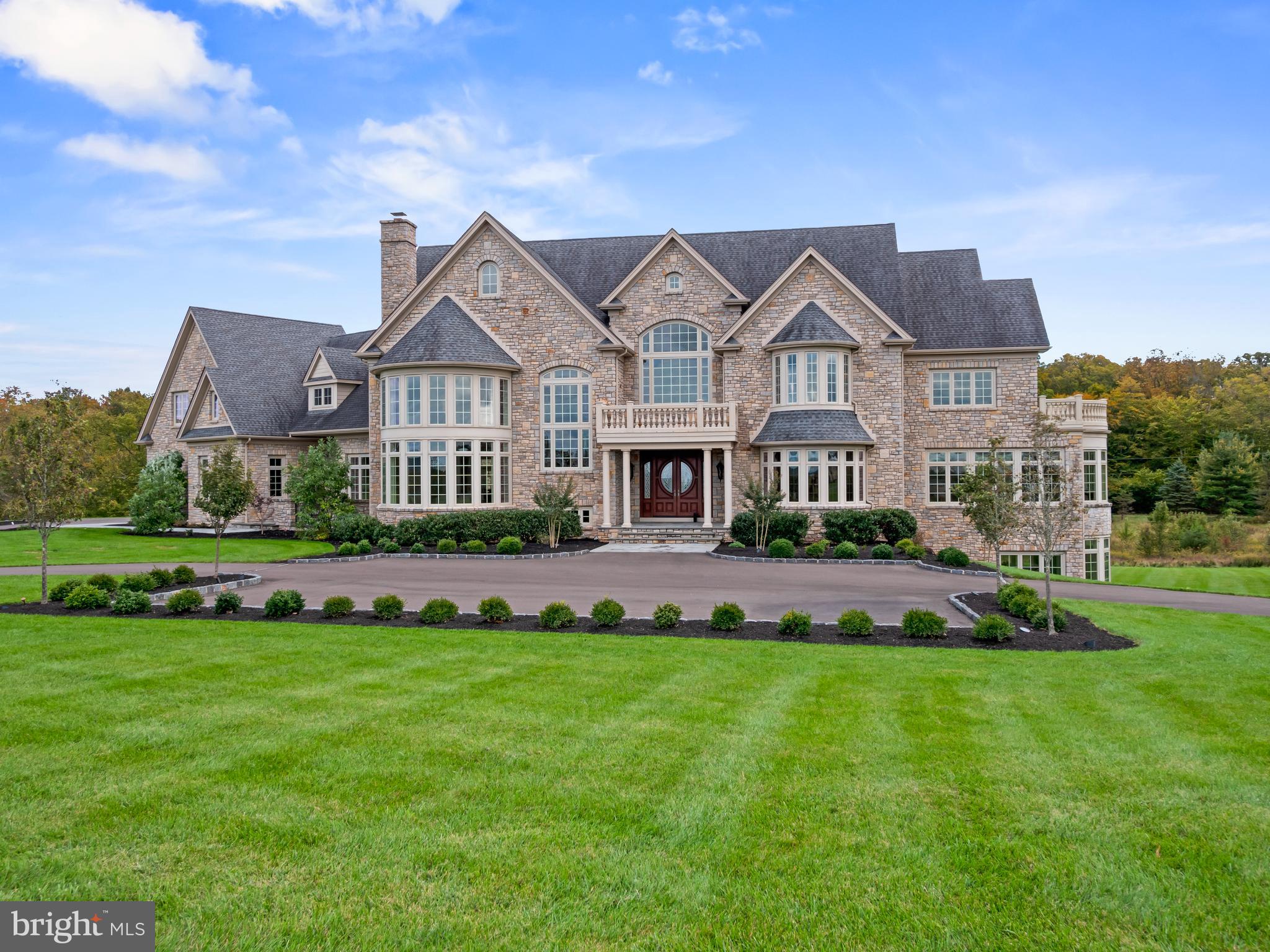 a front view of a house with a garden and plants