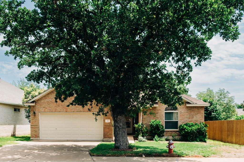 a front view of a house with trees