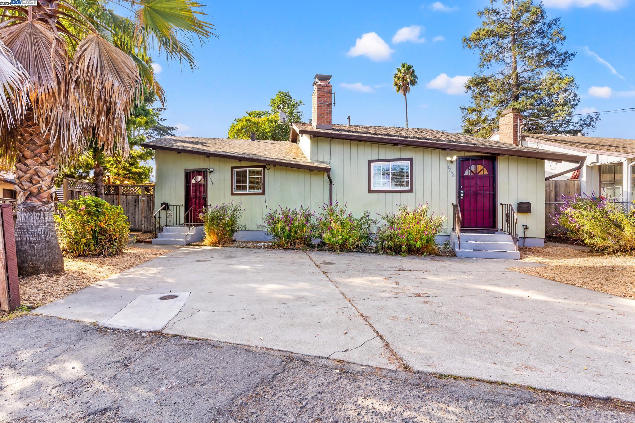 a front view of a house with a yard and a garage