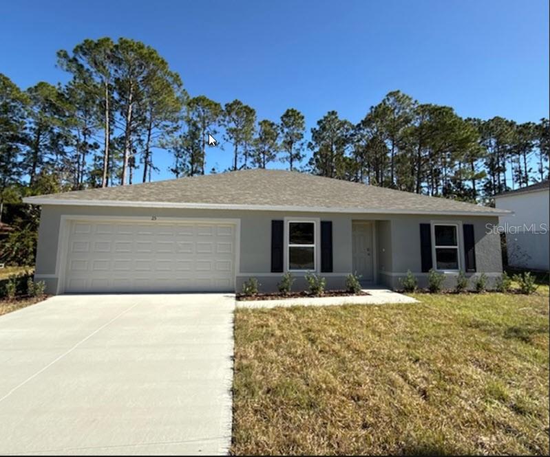 a front view of house with yard covered in the background