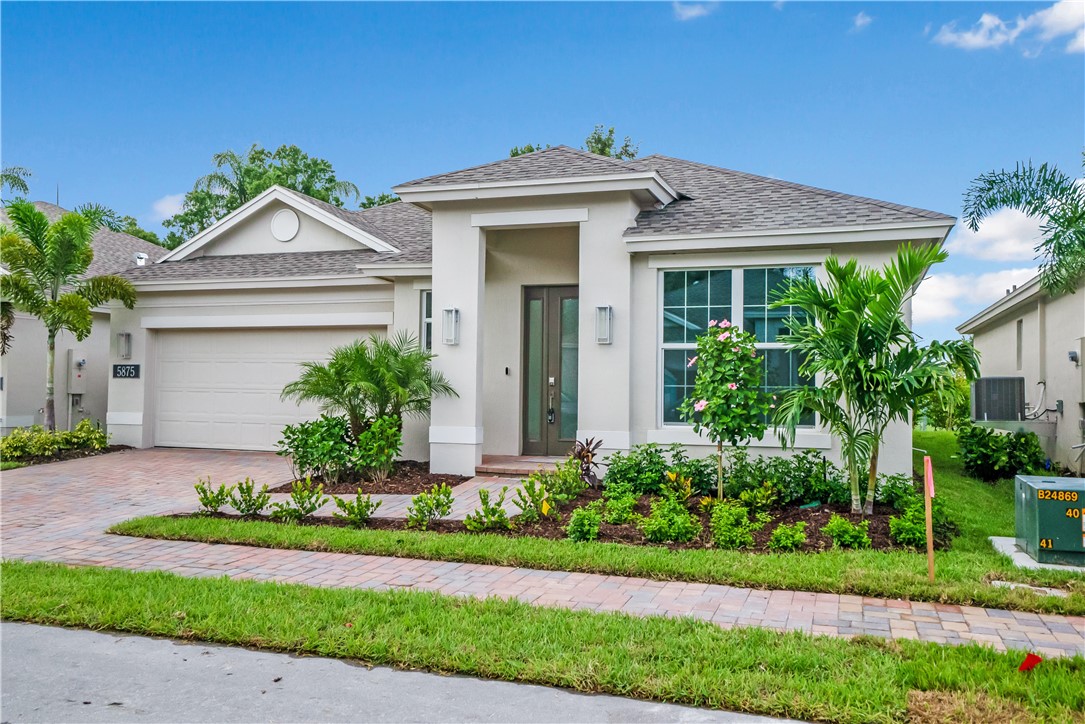 a view of a house with a small yard and plants