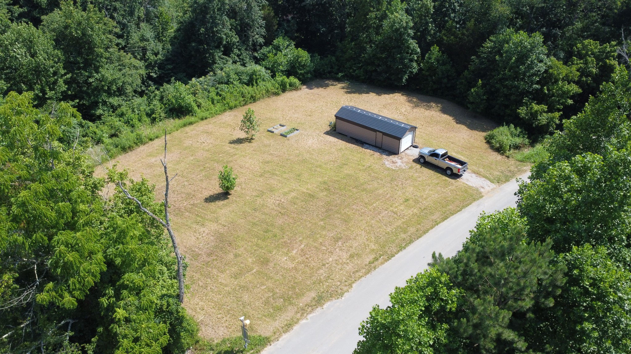 an aerial view of a house with a yard and trees