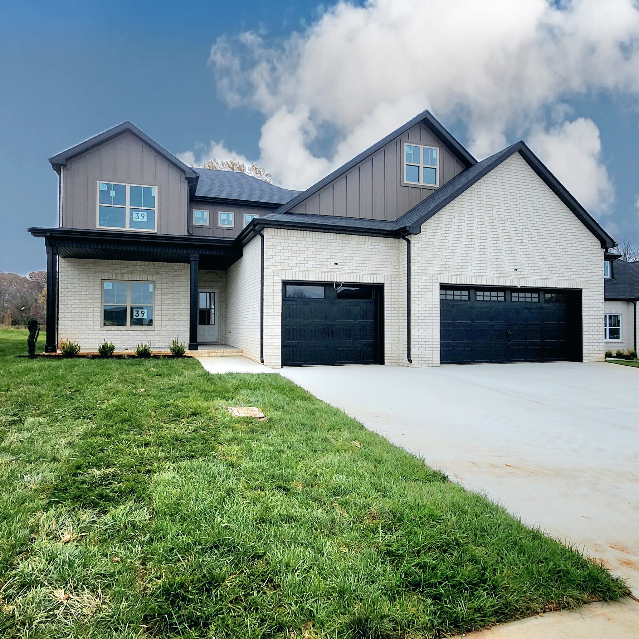 a front view of a house with a yard and garage