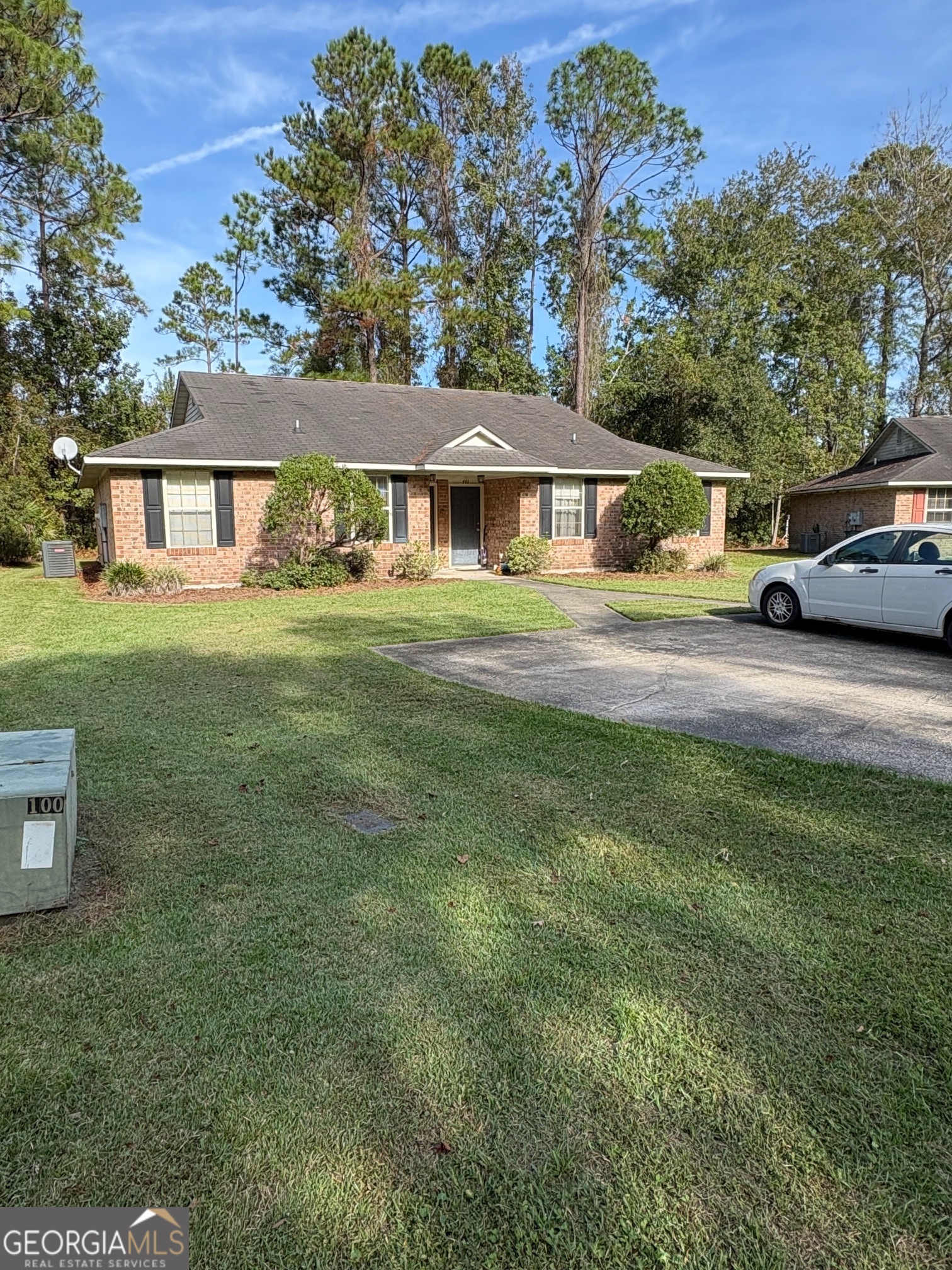 a front view of a house with a garden