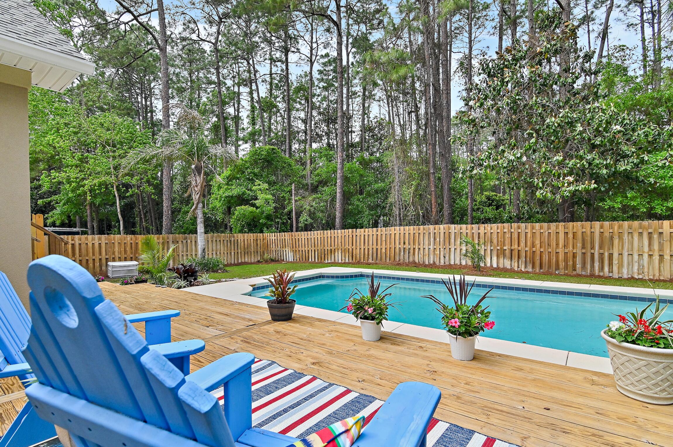 a backyard of a house with table and chairs